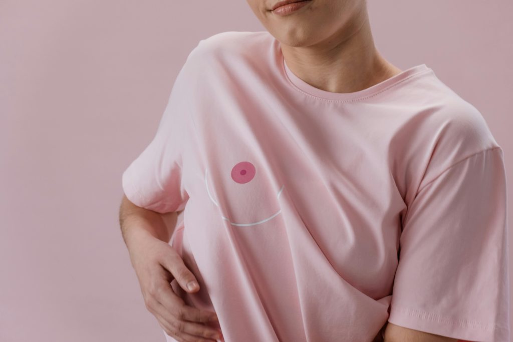 Person in a pink t-shirt symbolizing breast cancer awareness. Empowerment and health.